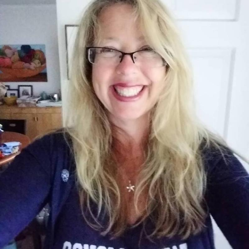 Selfie of a smiling woman wearing a blue Sonoma State top.